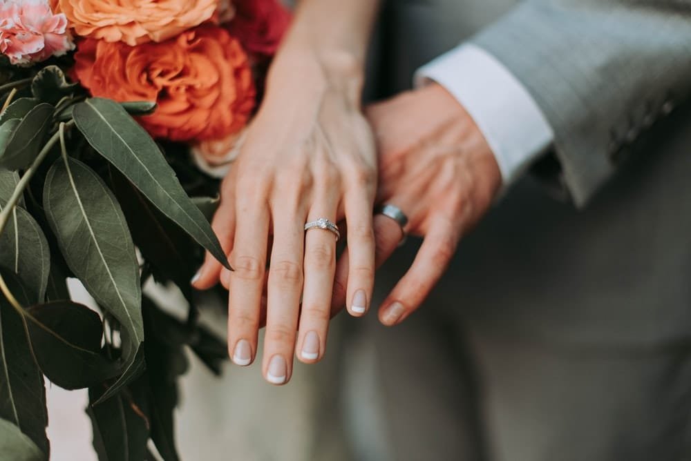 Description: couple wearing silver-colored rings