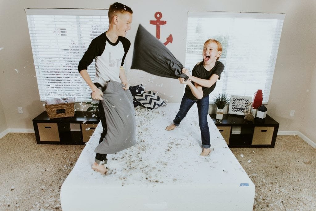 Description: boy and girl having pillow fight